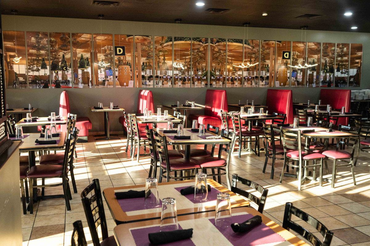The BLR Bar & Curry dining room, red booths and tables set for dinner service under warm light